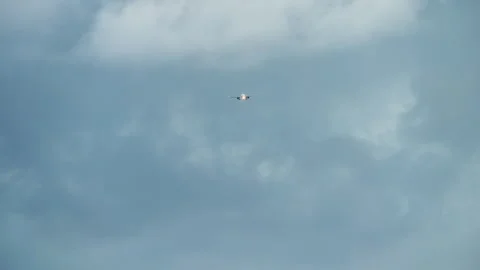 Airliner on approach through cloudy sky Stock Footage 346228684