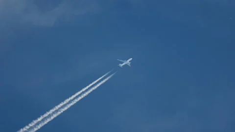 Airliner in blue sky, trail Stock Footage 165940341