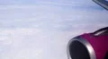 Airliner engine and thick white clouds, view through airplane porthole, tourism HD Footage