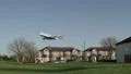Airliner flies low over houses HD Footage