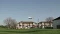 Airliner flies low over houses HD Footage