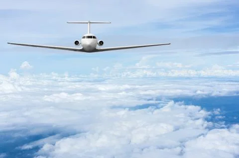 Airliner fly over clouds Stock Photos