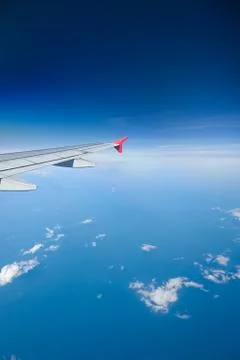 Airliner flying over clouds Stock Photos