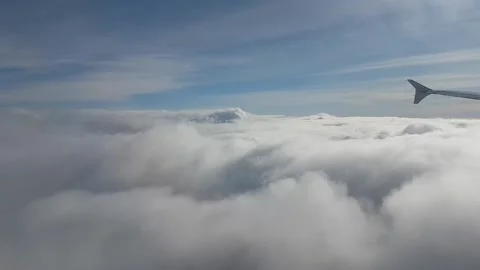 Airliner flying on top cumulus clouds Stock Footage 224932196