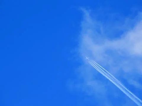 Airliner with jet trail Stock Photos