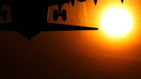 Airliner passing the sun, close-up Stock Footage