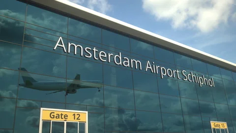 Airliner take off reflecting in the windows with Amsterdam Airport Schiphol text Vidéo 154158812