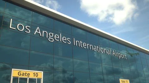 Airliner take off reflecting in the windows with Los Angeles International Ilustración de archivo