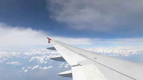Airliner Wing Between Two Layers Of Clouds Fly in the Blue Sky - Timelapse Stock Footage 228520053