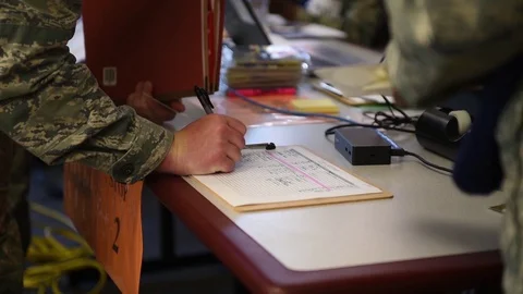 Airman completing paperwork during deployment processing Stock-Footage 91381432
