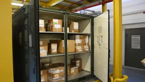 Airman placing parcel into cupboard for distribution Stock Footage 111998507