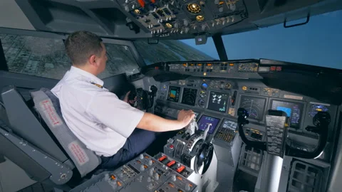 An airman sits in a flight simulator and turns a plane to the left. 4K. 스톡 동영상 88539120