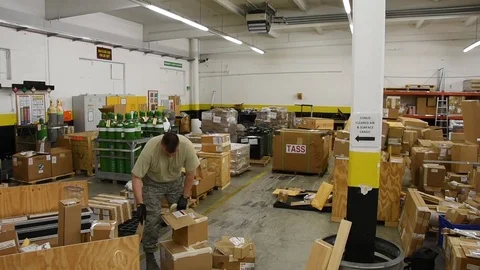 Airman sorting parcels at distribution warehouse Stock Footage 111998382