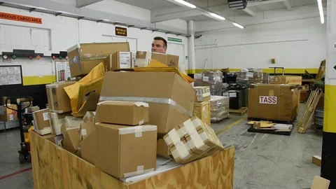 Airman sorting parcels at distribution warehouse Stock Footage 111998420