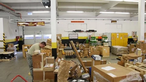 Airman sorting parcels at distribution warehouse Stock Footage 111998449