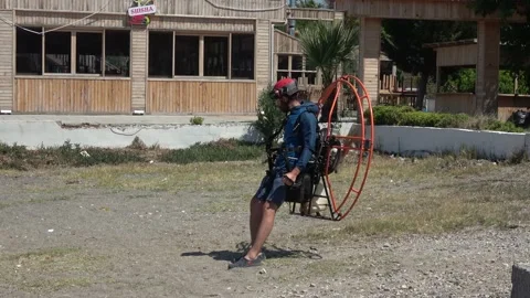 Airman testing engine power of his flying apparatus on the beach Stock Footage 142988655