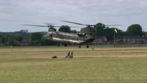 Airmen attaching harness to hovering RAF Chinook Stock Footage 276337081