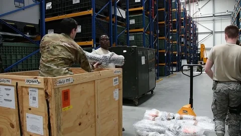 Airmen loading bubble wrapped rifles into wooden crate for transportation Stock Footage 111998547