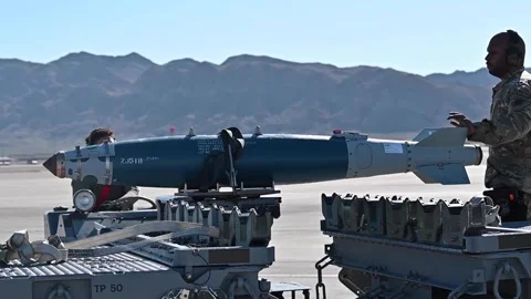 Airmen loading GBU-38 guided bomb unit onto bomb loader Stock Footage 269133393