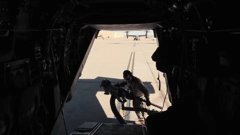 Airmen moving ramp mounted machine gun on CV-22 Osprey Stock Footage 86894613