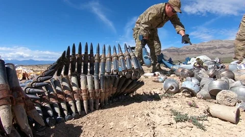 Airmen sorting out EOD's during range clearance operations in desert Stock Footage 111757279
