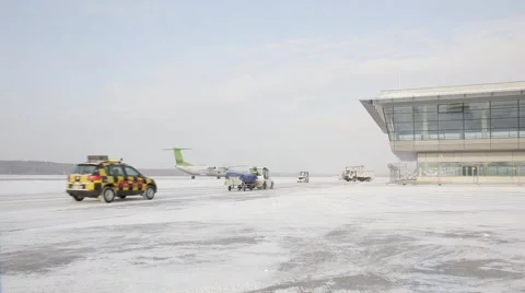 Airplain moving to runway in winter, service cars Stock Footage 60129341