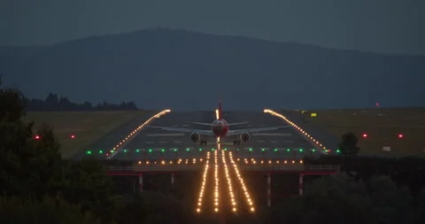 Airplane accelerating and taking off on illuminated runway Stock Footage 288696328