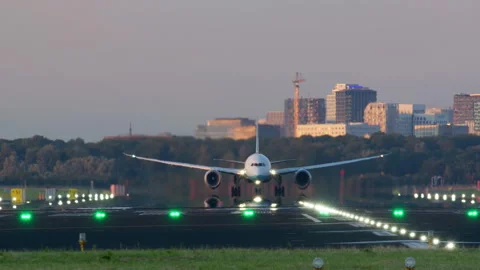 Airplane accelerating down the runway for takeoff into the evening sky Stock Footage 288709894
