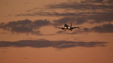 Airplane against dusk clouds Stock Footage 270145739