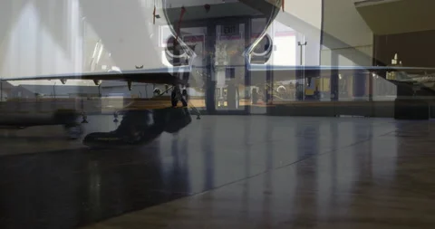 Airplane against low section of passengers walking in the airport Stock Footage 141238337