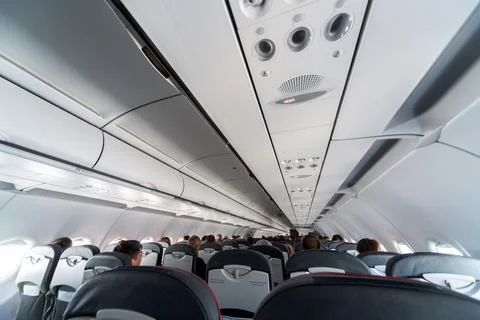 Airplane air conditioning control panel over seats. Stuffy air in aircraft ca Stock Photos