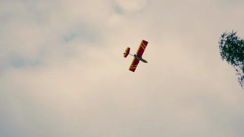 Airplane in the air. A plane flies under the clouds and hides behind the trees Stock Footage 236647550