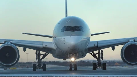 Airplane airbus a350 qatar airways taxiing front view late evening sky Stock Footage 124314416