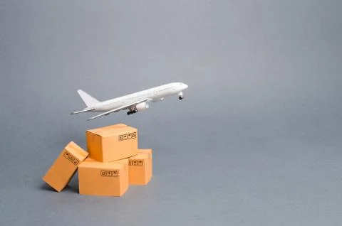 Airplane and stack of cardboard boxes. concept of air cargo and parcels, airm Stock Photos