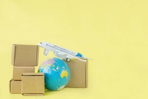 Airplane and stack of cardboard boxes. concept of air cargo and parcels, airm Stock Photos