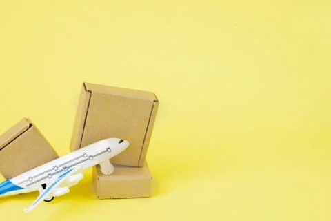 Airplane and stack of cardboard boxes. concept of air cargo and parcels, airm Stock Photos