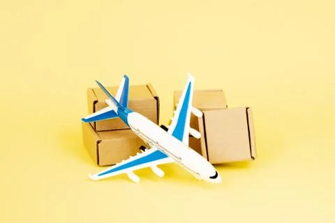 Airplane and stack of cardboard boxes. concept of air cargo and parcels, airm Stock Photos