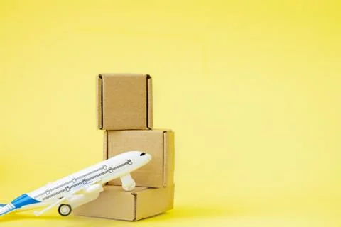 Airplane and stack of cardboard boxes. concept of air cargo and parcels, airm Stock Photos