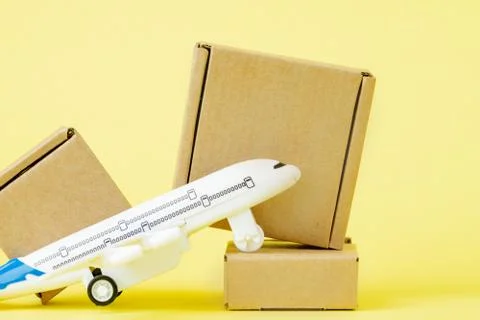 Airplane and stack of cardboard boxes. concept of air cargo and parcels, airm Stock Photos