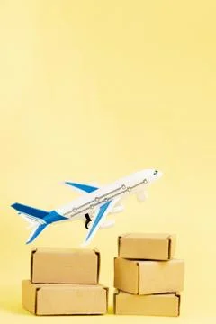 Airplane and stack of cardboard boxes. concept of air cargo and parcels, airm Stock Photos
