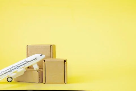 Airplane and stack of cardboard boxes. concept of air cargo and parcels, airm Stock Photos