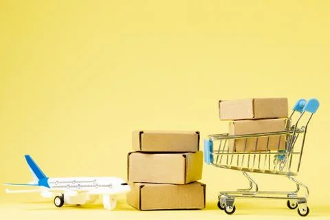 Airplane and stack of cardboard boxes. concept of air cargo and parcels, airm Stock Photos