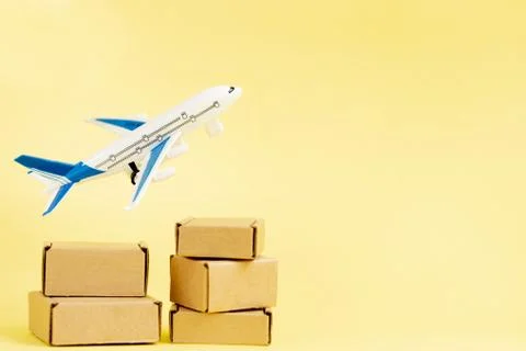 Airplane and stack of cardboard boxes. concept of air cargo and parcels, airm Stock Photos