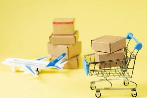 Airplane and stack of cardboard boxes. concept of air cargo and parcels, airm Stock Photos