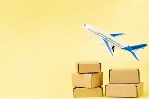 Airplane and stack of cardboard boxes. concept of air cargo and parcels, airm Stock Photos