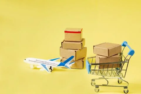 Airplane and stack of cardboard boxes. concept of air cargo and parcels, airm 스톡 사진