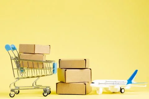 Airplane and stack of cardboard boxes. concept of air cargo and parcels, airm Stock Photos