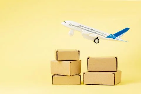 Airplane and stack of cardboard boxes. concept of air cargo and parcels, airm Stock Photos