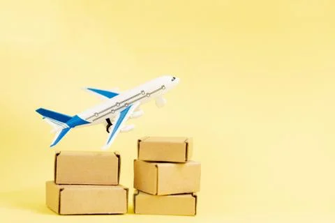 Airplane and stack of cardboard boxes. concept of air cargo and parcels, airm Stock Photos