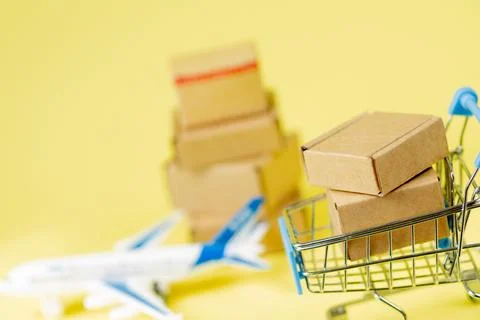 Airplane and stack of cardboard boxes. concept of air cargo and parcels, airm Stockfoto's